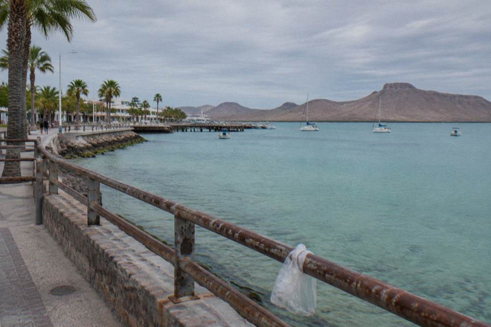 Turquoise shallow water of the La Paz bay at midmorning with distant hills