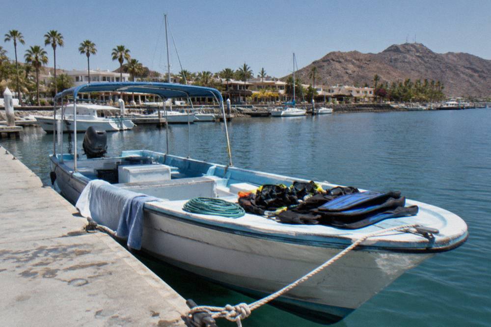 small tour boat at a marina dock in La Paz with snorkel gear stowed aboard