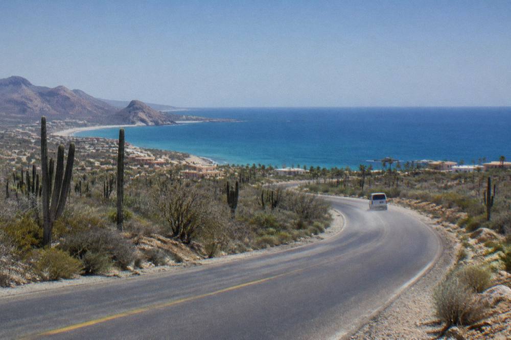 Coastal highway curving between desert scrub and open sea