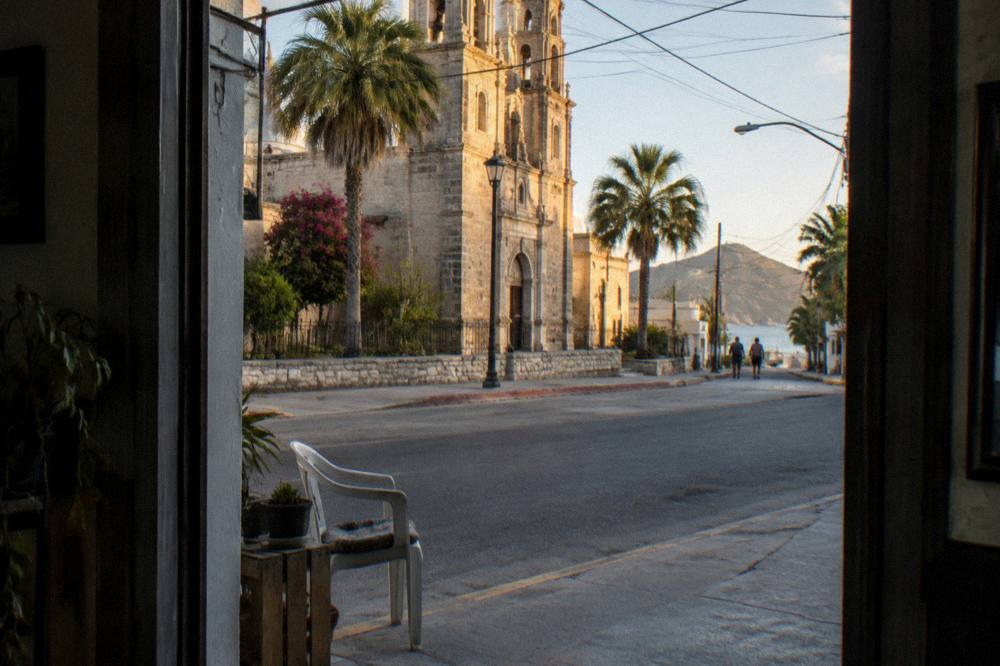 Historic downtown street in La Paz with stone cathedral facade in soft light
