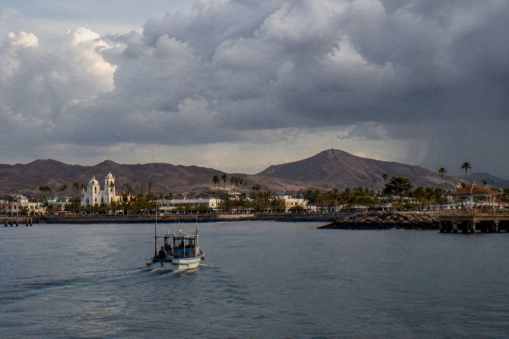 Clouds building over the bay and distant hills at La Paz in late afternoon