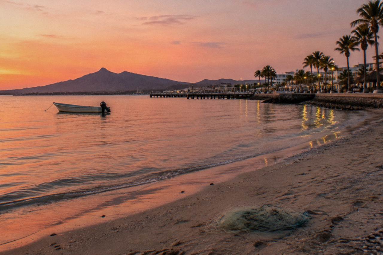 Quiet bay water near La Paz with a small boat anchored off a sandy shore