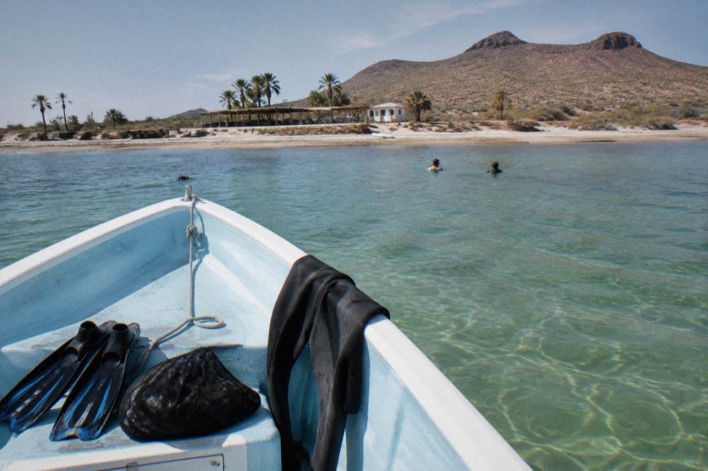 Snorkel boat anchored in clear shallow water in the bay near La Paz